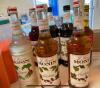 (11) ASSORTED FLAVOR SYRUPS AND SAUCES. W/ (6) PUMPS