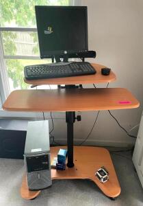 STANDING DESK WITH COMPUTER MONITOR AND KEYBOARD