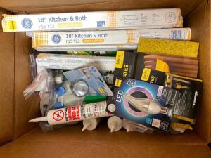 BOX OF ASSORTED LIGHT BULBS AND CAULK.