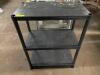 DESCRIPTION: 27" X 15" THREE TIER BLACK PLASTIC SHELF LOCATION: BAY 7 QTY: 1