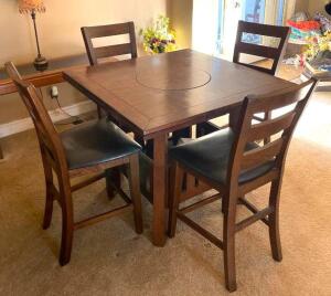 DESCRIPTION: 5PC WOODEN DINING TABLE SET WITH LAZY SUSAN CENTER AT PUB HEIGHT SIZE: 42"X42"X35" LOCATION: HOUSE #2 LOCATION: 6521 WOODLAND DRIVE CEDAR