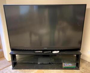DESCRIPTION: 73" 1080 PROJECTOR TV WITH ENTERTAINMENT STAND BRAND/MODEL: MITSUBISHI WD-73737 INFORMATION: SCREEN HAS CRACK BUT TV STILL WORKS LOCATION