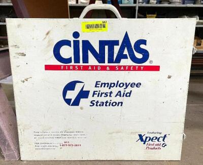 DESCRIPTION: CINTAS WALL MOUNTED FIRST AID CABINET LOCATION: WOOD TABLE / TIRE RACK AREA THIS LOT IS: ONE MONEY QTY: 1