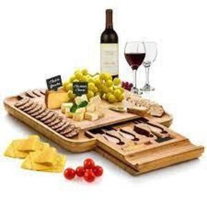 DESCRIPTION: (1) BAMBOO CHEESE BOARD AND CUTLERY SET WITH SLIDE OUT DOOR BRAND/MODEL: BAMBUSI RETAIL$: $50.00 EA SIZE: 13X13 QTY: 1