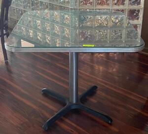 NAME: 35.5" DINING TABLE WITH GLASS PANEL TOP DESCRIPTION: 35.5" DINING TABLE WITH GLASS PANEL TOP ADDITIONAL INFORMATION: TABLE CLOTH NOT INCLUDED. C
