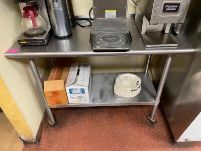 DESCRIPTION: 48" X 24" STAINLESS TABLE W/ 2" BACK SPLASH W/ LOWER STAINLESS SHELF. ADDITIONAL INFORMATION CONTENTS ARE NOT INCLUDED. TABLE IS MISSING