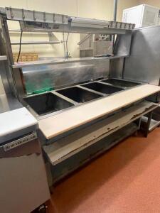 DESCRIPTION: DUKE FOUR WELL GAS STEAM TABLE W/ RISER SHELF AND APW 48" HEAT LAMP BRAND / MODEL: DUKE / APW ADDITIONAL INFORMATION NATURAL GAS. SIZE 60