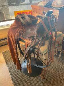 DESCRIPTION: WESTERN SADDLE W/ BRIDAL AND BIT. ADDITIONAL INFORMATION W/ CHAPS LOCATION: ENTRANCE THIS LOT IS: ONE MONEY QTY: 1