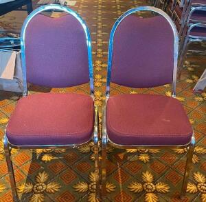 (8) STACK CHAIRS W/ MAROON UPHOLSTERED SEATS.