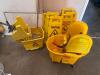 DESCRIPTION: (2) MOP BUCKETS AND (4) WET FLOOR SIGNS LOCATION: WAREHOUSE THIS LOT IS: ONE MONEY QTY: 1