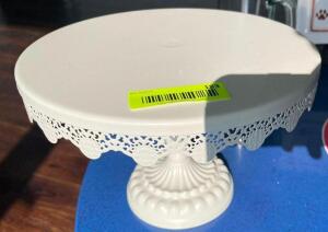 DESCRIPTION: SMALL METAL CAKE STAND LOCATION: FRONT QTY: 1