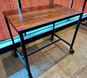 48" X 30" HARDWOOD TABLE TOP W/ METAL FRAME AND CASTERS. (PUB HEIGHT)