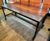 72" X 30" HARDWOOD TABLE TOP W/ METAL FRAME AND CASTERS.