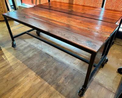 72" X 30" HARDWOOD TABLE TOP W/ METAL FRAME AND CASTERS.