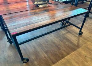 72" X 30" HARDWOOD TABLE TOP W/ METAL FRAME AND CASTERS.
