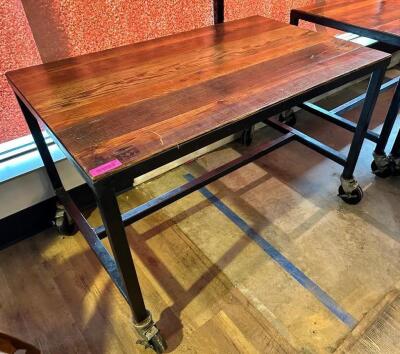 48" X 30" HARDWOOD TABLE TOP W/ METAL FRAME AND CASTERS.