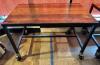 48" X 30" HARDWOOD TABLE TOP W/ METAL FRAME AND CASTERS.