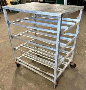 DESCRIPTION: 26" X 35" HALF SIZE CAN RACK W/ STAINLESS TABLE TOP. ON CASTERS. LOCATION: BAY 6 QTY: 1