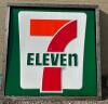 LARGE PLASTIC 7 ELEVEN SIGN IN WOODEN FRAME