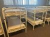 DESCRIPTION: (2) - TWIN OVER TWIN WHITE METAL FRAMED BUNK BEDS WITH MATTRESSES RETAIL PRICE: $233.80 EACH ADDITIONAL INFORMATION: (2) - BUNK BEDS TOTA - 2