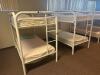 DESCRIPTION: (2) - TWIN OVER TWIN WHITE METAL FRAMED BUNK BEDS WITH MATTRESSES RETAIL PRICE: $233.80 EACH ADDITIONAL INFORMATION: (2) - BUNK BEDS TOTA - 2