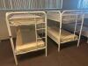 DESCRIPTION: (2) - TWIN OVER TWIN WHITE METAL FRAMED BUNK BEDS WITH MATTRESSES RETAIL PRICE: $233.80 EACH ADDITIONAL INFORMATION: (2) - BUNK BEDS TOTA - 2