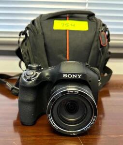 DESCRIPTION: CYBER-SHOT 20.1 MP DIGITAL CAMERA WITH CASE BRAND/MODEL: SONY DSC-H300 LOCATION: CORNER OFFICE QTY: 1