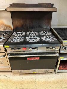 DESCRIPTION: VULCAN SIX BURNER GAS RANGE W/ LOWER OVEN BRAND / MODEL: VULCAN ADDITIONAL INFORMATION NATURAL GAS, CLEAN. W/ STAINLESS OVER SHELF LOCATI