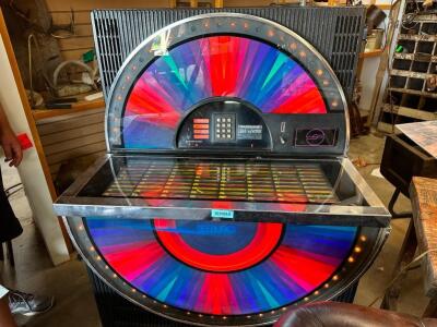 DESCRIPTION: SEEBURG JUKE BOX PLAYER WITH RECORDS INFORMATION: SOUNDS GREAT, MAY NEED TO BE REWIRED WITH UPDATED WIRING SIZE: 3'5"X4'5" QTY: 1