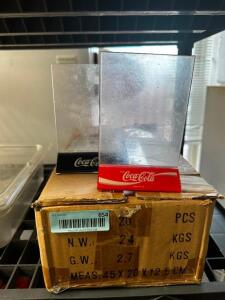 DESCRIPTION: (1) BOX OF " COKE " PLASTIC TABLE TENTS - APPROX 10 LOCATION: OFFICE THIS LOT IS: ONE MONEY QTY: 1