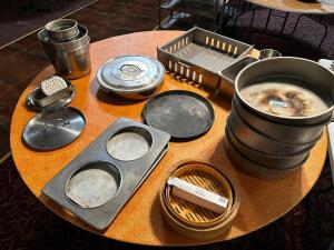 DESCRIPTION: CONTENTS OF TABLE - ASSORTED PANS, INSERTS, AND LIDS LOCATION: MAIN SEATING THIS LOT IS: ONE MONEY QTY: 1