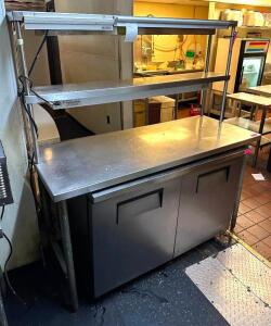 DESCRIPTION: 60" STAINLESS TABLE WITH DOUBLE RISER SHELF AND INFRARED HEATER ATTACHMENTS BRAND/MODEL: WINCO SIZE: 60"X24"X36" LOCATION: KITCHEN QTY: 1