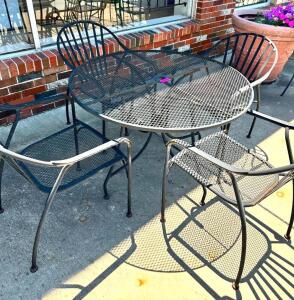 DESCRIPTION: WROUGHT IRON TABLE W/ 4 METAL CHAIRS SIZE: 42" LOCATION: FRONT PATIO QTY: 1