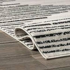 DESCRIPTION: (1) AREA RUG BRAND/MODEL: NULOOM INFORMATION: BLACK AND WHITE SIZE: 6'7" X 9' RETAIL$: $69.56 EA QTY: 1