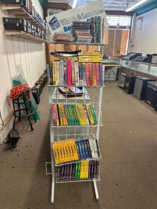 LARGE DISPLAY RACK WITH ASSORTED VHS INSTRUCTIONAL VIDEOS