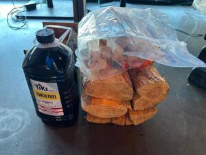 (1) BOTTLE OF TORCH FUEL AND ASSORTED LOGS AND KINDLING.