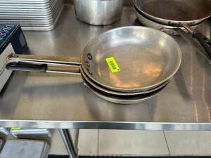 NAME: (3)- SKILLETS DESCRIPTION: (3)- SKILLETS SIZE: 10" LOCATION: FRONT ENTRANCE QTY: 3