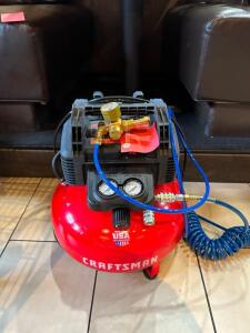 DESCRIPTION: 6 GALLON AIR COMPRESSOR WITH ATTACHMENTS BRAND/MODEL: CRAFTSMAN LOCATION: DINING AREA QTY: 1