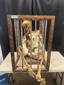 DESCRIPTION SKELETON PROP IN HANGING CAGE. QTY 1