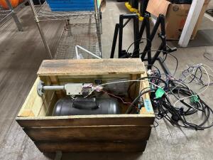 DESCRIPTION 5 GALLON AIR CANON / TANK WITH WOOD BOX ENCLOSURE. ADDITIONAL INFORMATION W/ REGULATOR AND PROP CONTROL UNIT AND METAL EXTENSION FRAME. QT