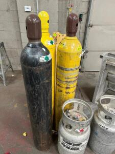 (3) TALL GAS CYLINDERS.