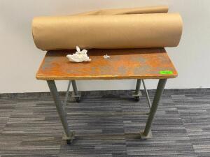 ROLLING UTILITY TABLE WITH ROLL OF MULTIPURPOSE PAPER