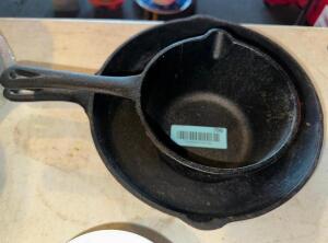 CAST IRON SKILLET AND (1) CAST IRON SAUCE POT.