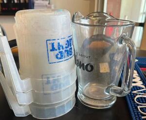 (4) ASSORTED GLASS AND PLASTIC BEER PITCHERS.