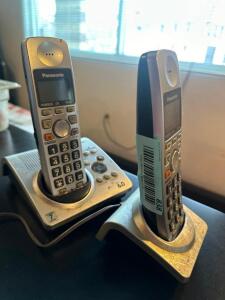 (2) CORDLESS PHONES W/ CHARGING BASES.