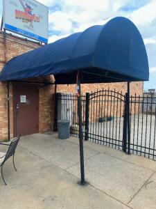 9' X 5' METAL AWNING W/ BLUE CANVAS COVER.