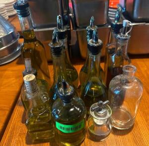 DESCRIPTION (8) ASSORTED OLIVE OIL DECANTERS. THIS LOT IS: ONE MONEY LOCATION ROOM 1 QTY 1