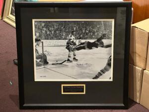 DESCRIPTION: "1970 STANLEY CUP GAME WINNING GOAL" FRAMED PRINT ADDITIONAL INFORMATION: SIGNED BY BOBBY ORR. INCLUDES CERTIFICATE OF AUTHENTICITY. SIZE