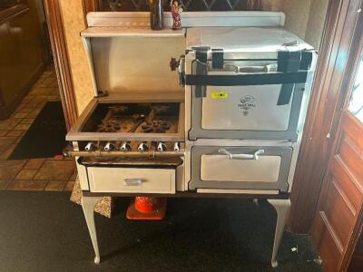 DESCRIPTION: VINTAGE QUICK MEAL STOVE ADDITIONAL INFORMATION: ONE DOOR IS HELD WITH TAPE. ORIGINAL PARTS. SEE PHOTOS. LOCATION: ENTRANCE THIS LOT IS: