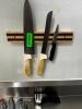 DESCRIPTION (3) KITCHEN KNIVES, MAGNETIC RACK, AND (1) SHARPENER. LOCATION KITCHEN QTY 1 - 2